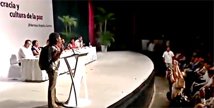 Video screenshot of 27-year old Ana Gatica challenging Menchú at a May 29, 2015 government organized forum. 
