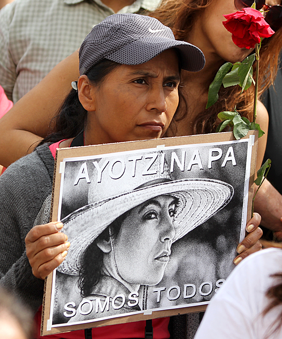 On March 22, 2015, thousands of Angelenos joined relatives of the Ayotzinapa 43 in a protest march on the Mexican Consulate in Los Angeles. In this photo one of the marchers holds the poster, "We Are All Ayotzinapa." Photo/Mark Vallen ©